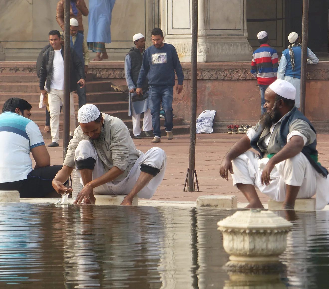 Men making wudu at a masjid ablution pool